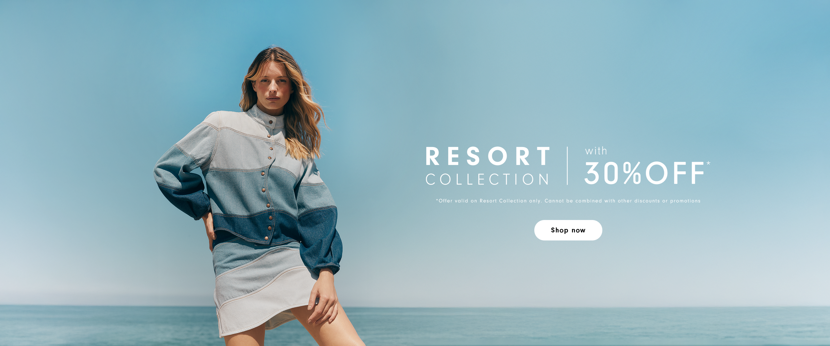 Desktop home banner with woman in a color-block denim jacket by the ocean, Resort Collection with 30% off promotion and Shop now button