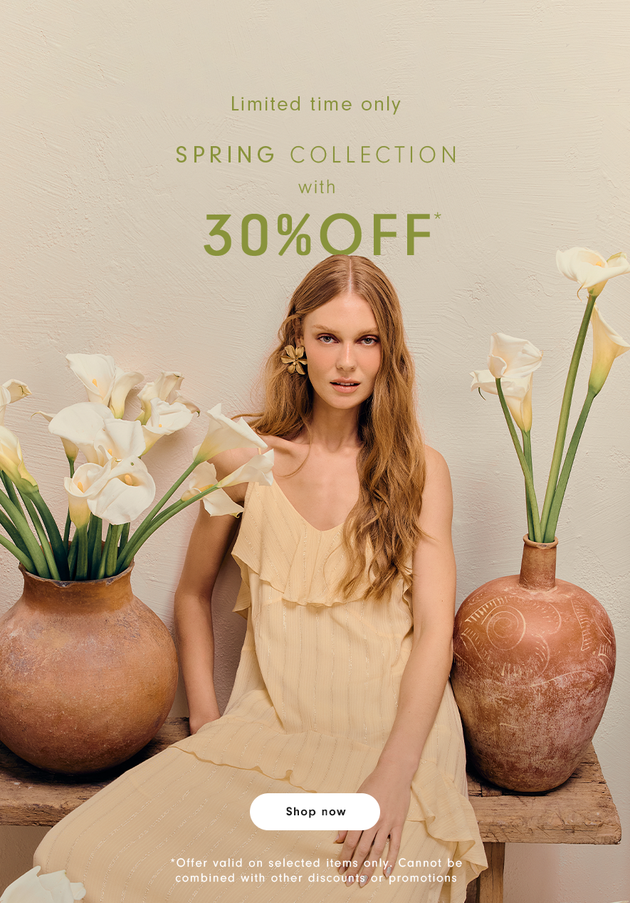 Mobile banner of a woman with long blonde hair wearing a beige ruffled dress, seated between two rustic terracotta vases filled with white calla lilies. Text reads "Limited time only - Spring Collection with 30% Off" and a "Shop now" button.