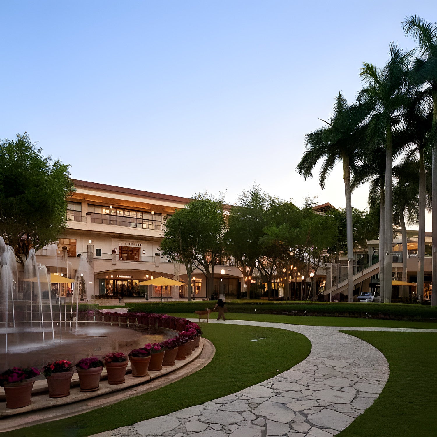 Shops at Merrick Park in Coral Gables at dusk, with its fountain, palm trees and arcades
