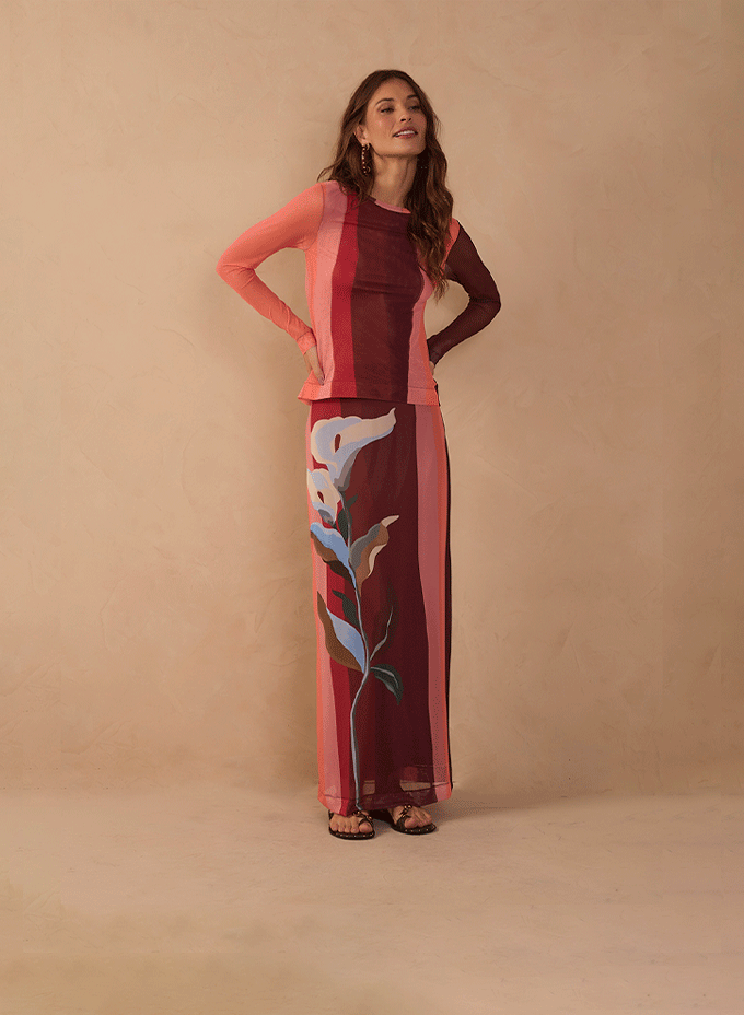 Model in a pink and burgundy color-blocked top and floral print maxi skirt - Must-haves category banner