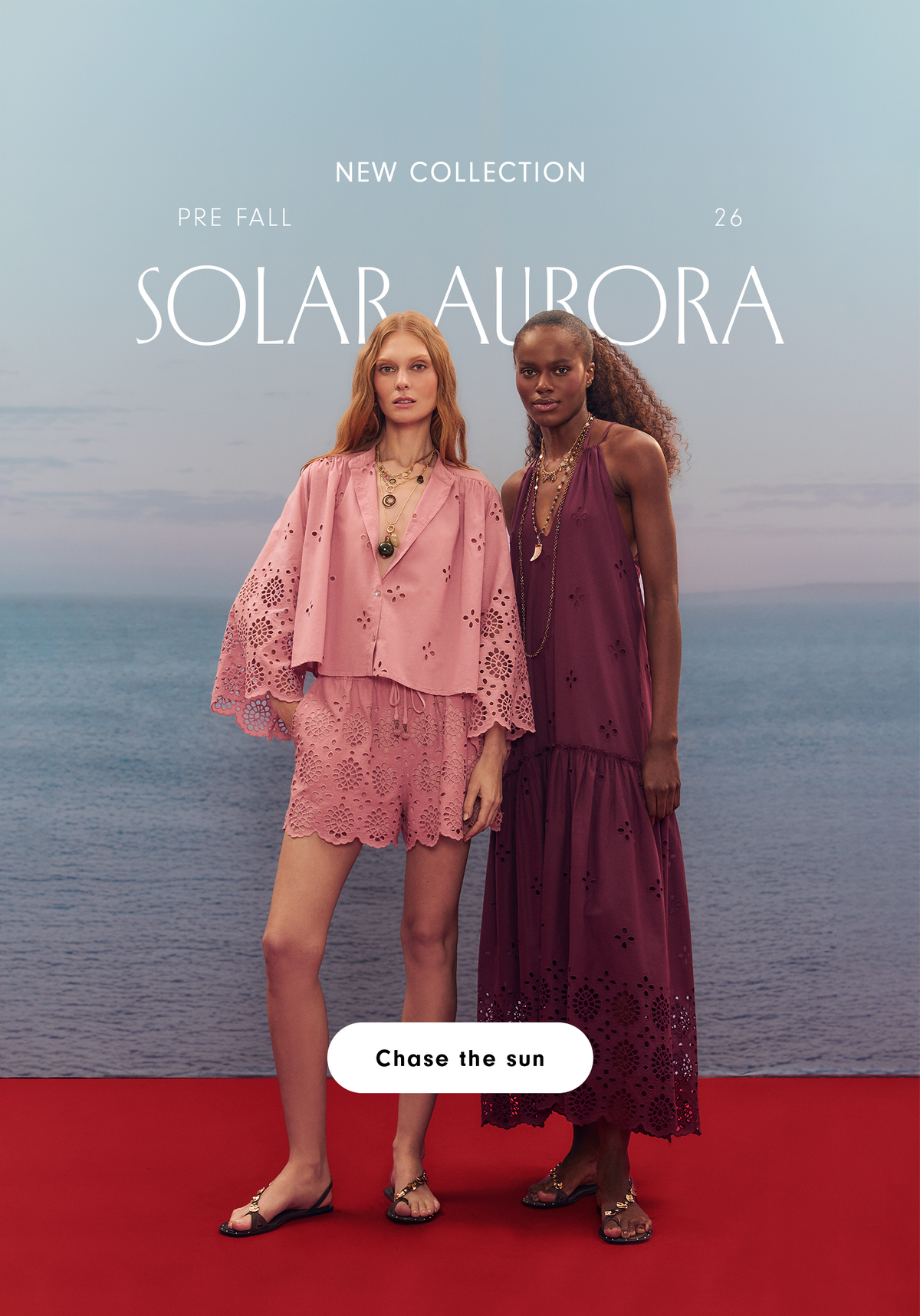 Pre Fall 26 Solar Aurora new collection mobile banner: two women by the sea on a red platform, one in a pink eyelet set and one in a burgundy dress, with a Chase the sun button