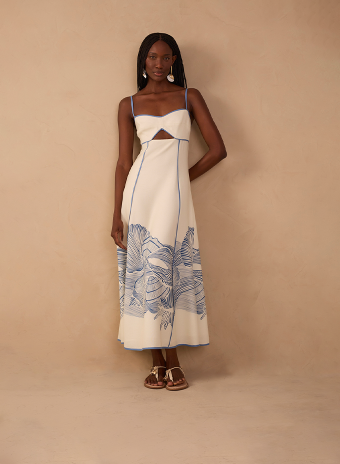 Model wearing white midi dress with blue floral print and front cutout - Dresses category